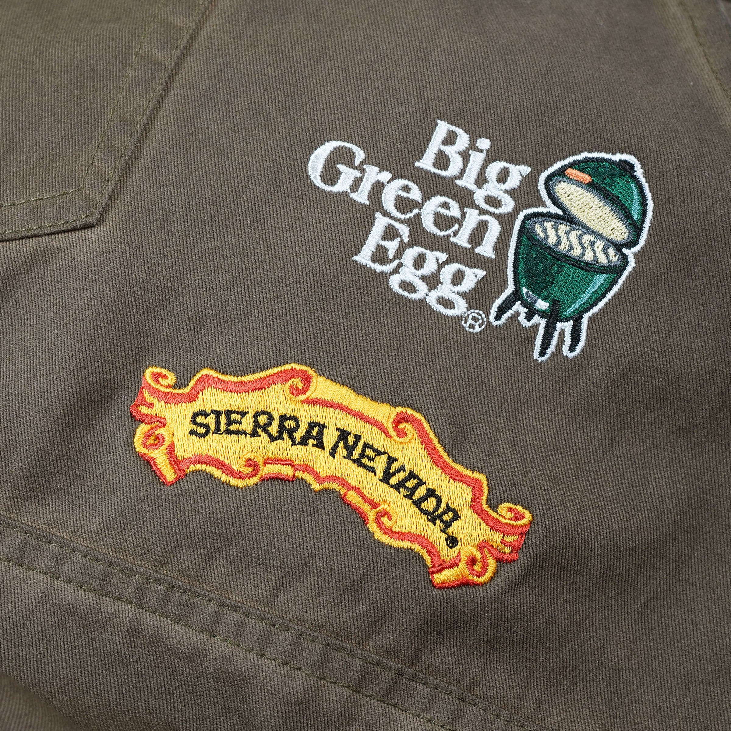 Close-up view of the two logos embroidered on the Sierra Nevada Big Green Egg Grilling Apron