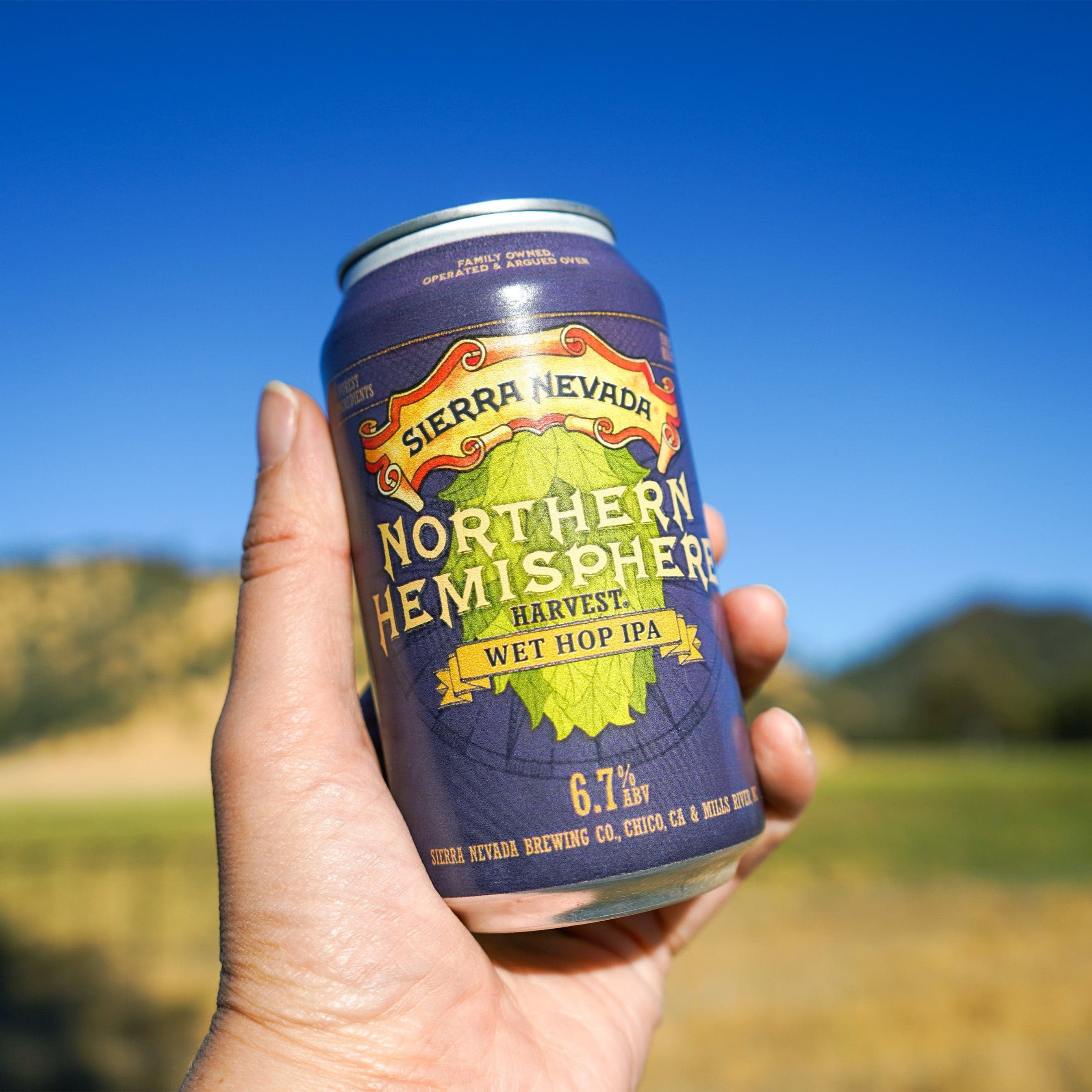 Sierra Nevada Northern Hemisphere Wet Hop IPA can held aloft in a person's hand