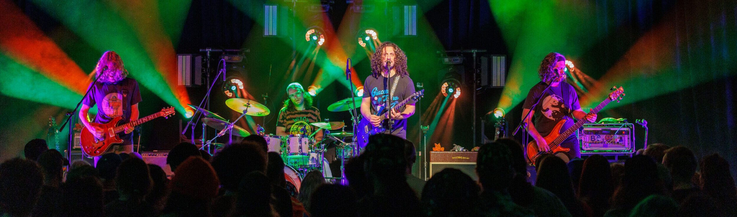 Crowd cheering for band playing on stage